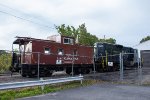 A Lackawanna Caboose and a PRR Geep sit outside the URHS Shops 